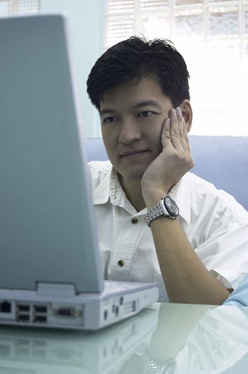 man looking at laptop, Cedars at Carver Park Galveston, TX